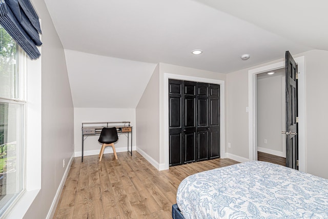 501 Spring Beach Rd, Rome City, IN 46784 - bedroom with light wood-style floors, baseboards, lofted ceiling, and recessed lighting