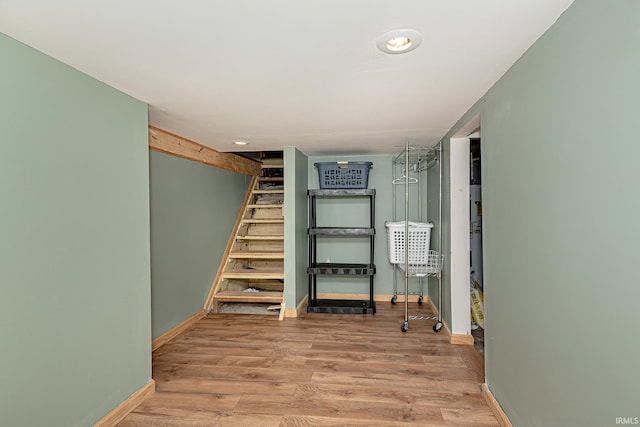 501 Spring Beach Rd, Rome City, IN 46784 - hallway featuring baseboards, wood finished floors, and stairway