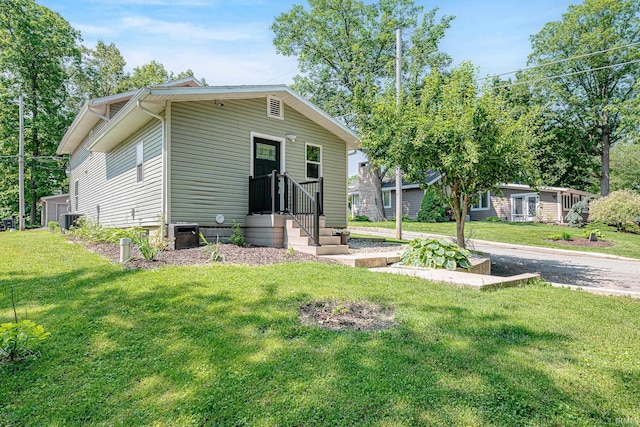 501 Spring Beach Rd, Rome City, IN 46784 - view of front of property featuring central AC unit and a front lawn