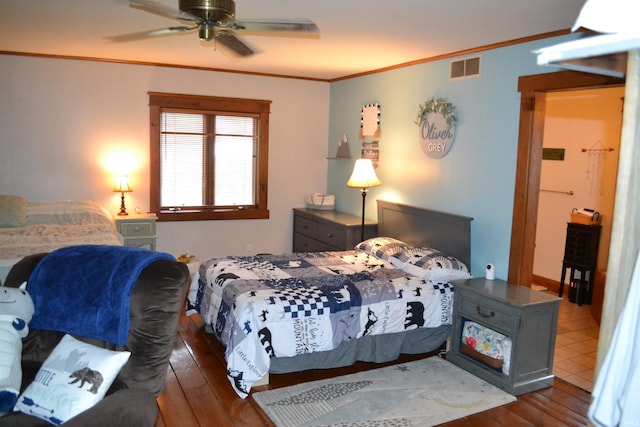 523 S Bluff St, Monticello, IN 47960 - bedroom with wood-type flooring, crown molding, and ceiling fan