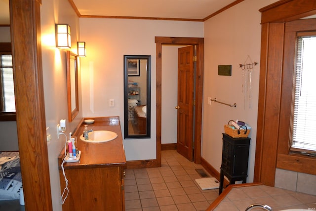 523 S Bluff St, Monticello, IN 47960 - bathroom featuring vanity, tile patterned flooring, crown molding, ensuite bathroom, and baseboards