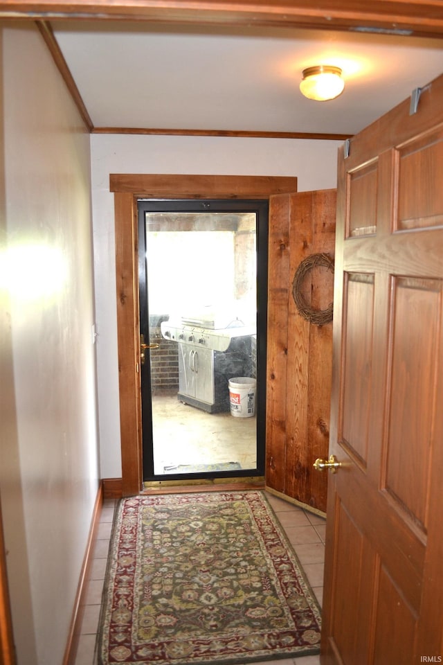 523 S Bluff St, Monticello, IN 47960 - doorway to outside featuring light tile patterned floors, baseboards, and crown molding