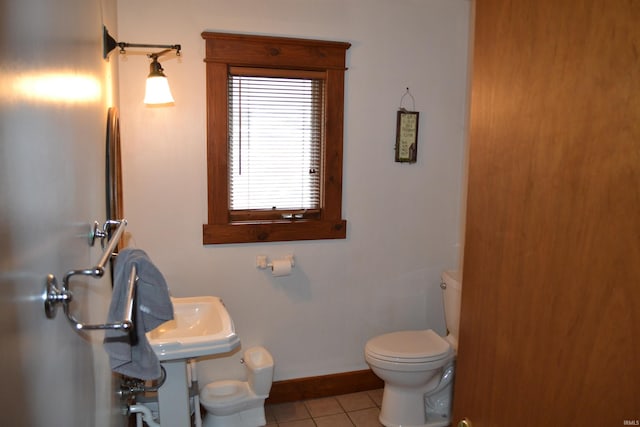 523 S Bluff St, Monticello, IN 47960 - bathroom with toilet, baseboards, and tile patterned flooring