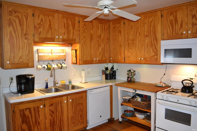523 S Bluff St, Monticello, IN 47960 - kitchen with white appliances, a sink, a ceiling fan, light countertops, and brown cabinetry