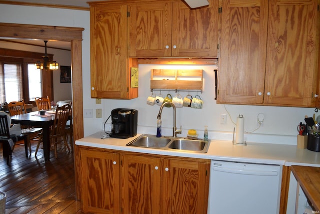 523 S Bluff St, Monticello, IN 47960 - kitchen featuring dishwasher, a sink, light countertops, and brown cabinetry