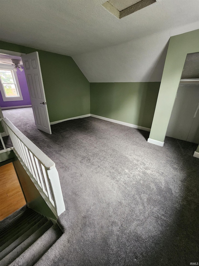 206 S Van Buren St, Monroe, IN 46772 - additional living space with baseboards, lofted ceiling, carpet floors, a textured ceiling, and ceiling fan
