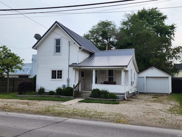 206 S Van Buren St, Monroe, IN 46772 - view of front of property with a porch, a detached garage, an outbuilding, metal roof, and driveway