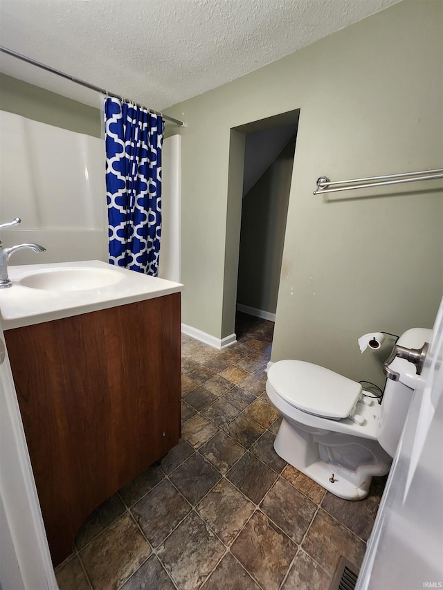206 S Van Buren St, Monroe, IN 46772 - full bath featuring toilet, vanity, stone finish flooring, a textured ceiling, and a shower with shower curtain