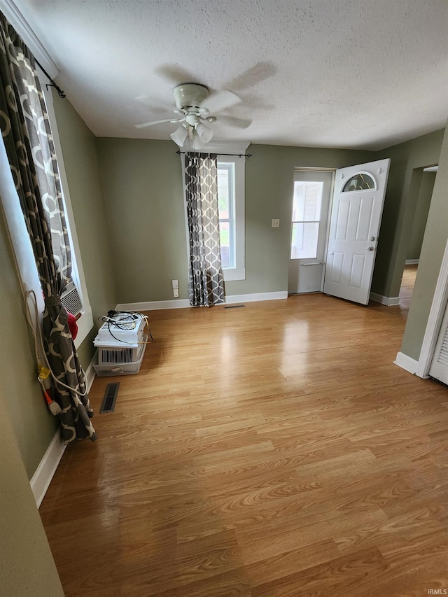 206 S Van Buren St, Monroe, IN 46772 - entrance foyer with a ceiling fan, a textured ceiling, light wood-type flooring, and baseboards