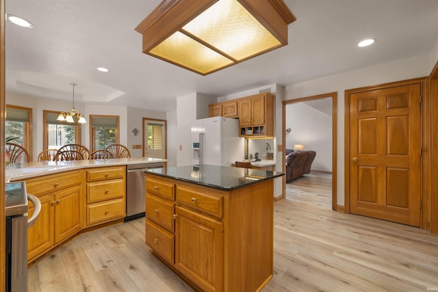 6615 Cherry Hill Pkwy, Fort Wayne, IN 46835 - kitchen with stainless steel dishwasher, white fridge with ice dispenser, light wood finished floors, recessed lighting, and a center island