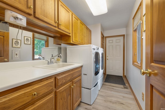 6615 Cherry Hill Pkwy, Fort Wayne, IN 46835 - laundry area with separate washer and dryer, cabinet space, light wood-style floors, and baseboards