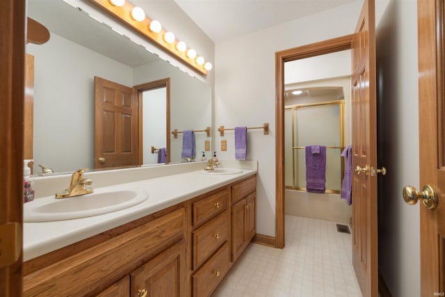 6615 Cherry Hill Pkwy, Fort Wayne, IN 46835 - bathroom with double vanity, tile patterned floors, and enclosed tub / shower combo