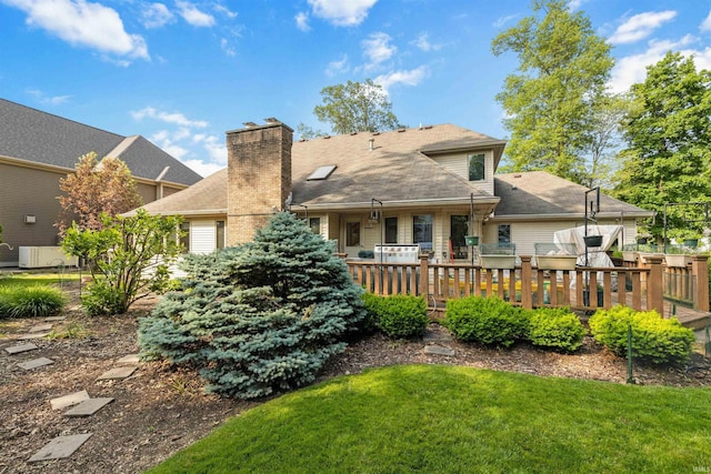 6615 Cherry Hill Pkwy, Fort Wayne, IN 46835 - back of property featuring a yard, a chimney, and a wooden deck