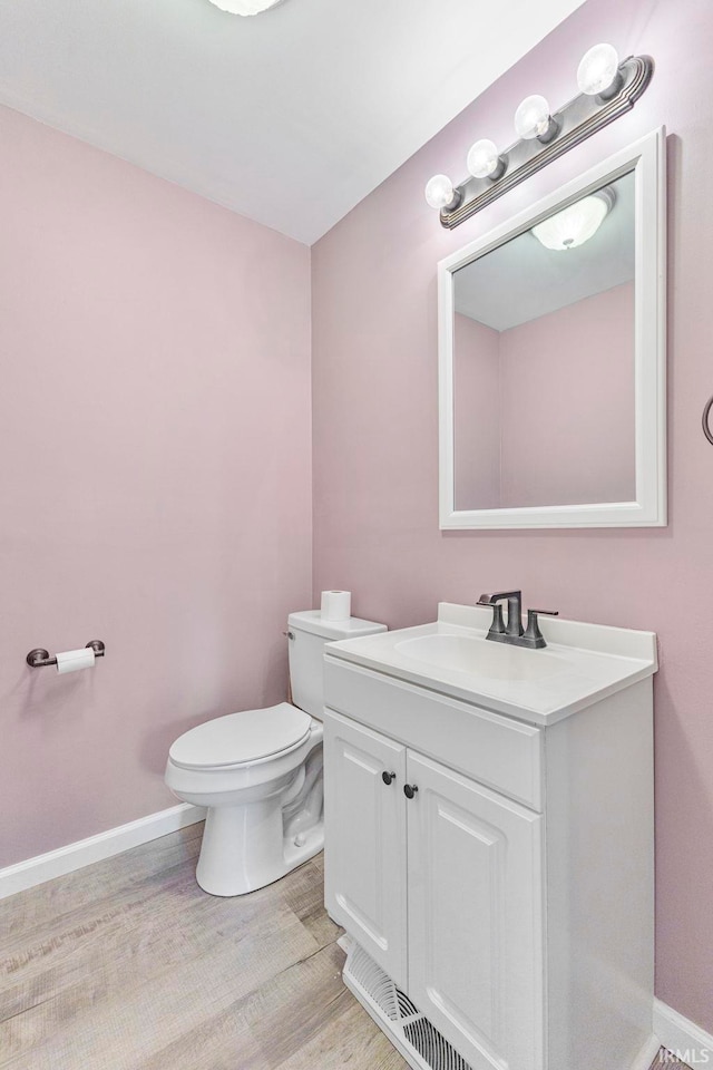 340 W Turner St, Bloomfield, IN 47424 - bathroom with vanity, toilet, wood finished floors, and baseboards