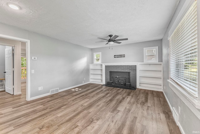 340 W Turner St, Bloomfield, IN 47424 - unfurnished living room with a textured ceiling, wood finished floors, ceiling fan, healthy amount of natural light, and baseboards