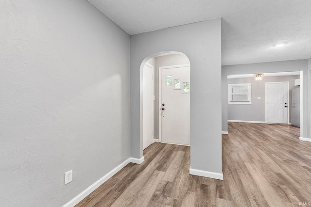 340 W Turner St, Bloomfield, IN 47424 - foyer entrance with wood finished floors, baseboards, arched walkways, and a textured ceiling