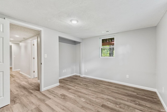 340 W Turner St, Bloomfield, IN 47424 - basement with light wood-style flooring, baseboards, and a textured ceiling