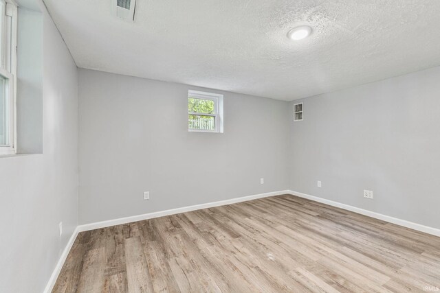 340 W Turner St, Bloomfield, IN 47424 - empty room with wood finished floors, a textured ceiling, and baseboards