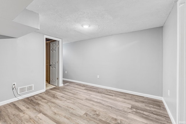 340 W Turner St, Bloomfield, IN 47424 - spare room with wood finished floors, baseboards, and a textured ceiling