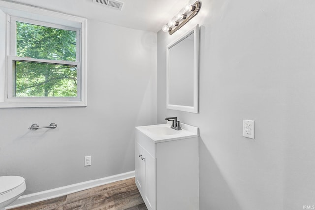 340 W Turner St, Bloomfield, IN 47424 - half bathroom featuring vanity, toilet, wood finished floors, and baseboards