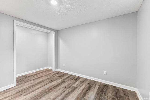 340 W Turner St, Bloomfield, IN 47424 - spare room featuring wood finished floors, baseboards, and a textured ceiling