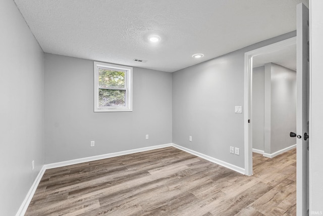 340 W Turner St, Bloomfield, IN 47424 - spare room with wood finished floors, a textured ceiling, baseboards, and recessed lighting