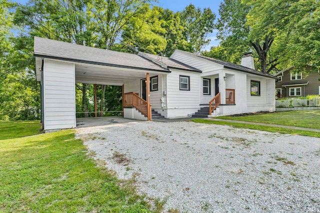 340 W Turner St, Bloomfield, IN 47424 - view of front of home with gravel driveway, a chimney, and a carport