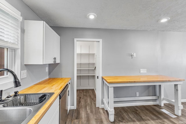 340 W Turner St, Bloomfield, IN 47424 - kitchen featuring a sink, wooden counters, dishwasher, dark wood finished floors, and white cabinets
