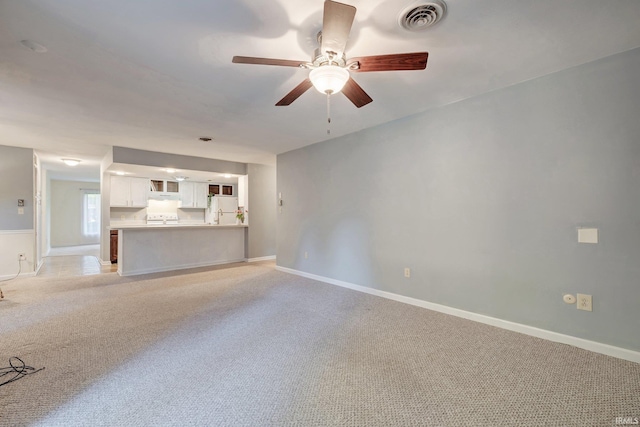 532 Bex Addition Dr, Bedford, IN 47421 - unfurnished living room with ceiling fan, light colored carpet, and baseboards