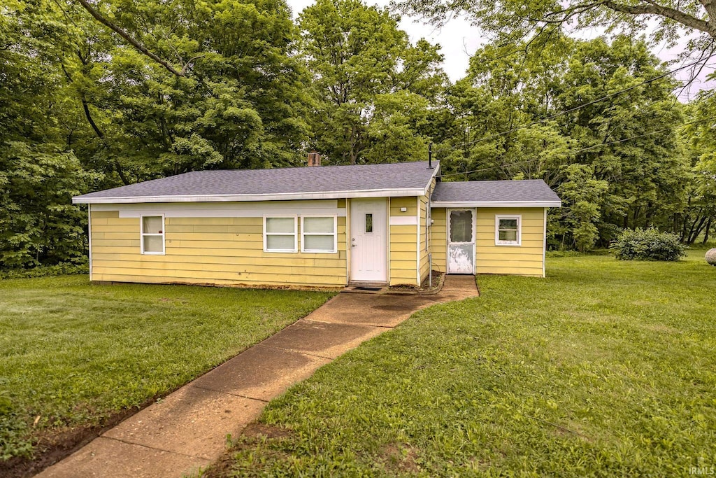 7921 S 700 W Rd, Williamsport, IN 47993 - bungalow-style home with a front lawn and roof with shingles