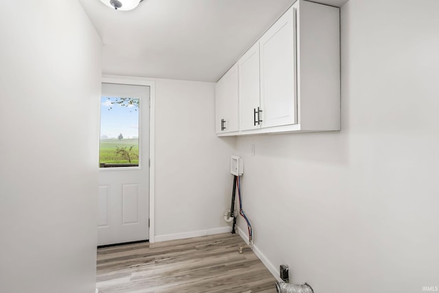 503 Graceland Ave, Claypool, IN 46510 - laundry room with cabinet space, light wood-type flooring, and baseboards