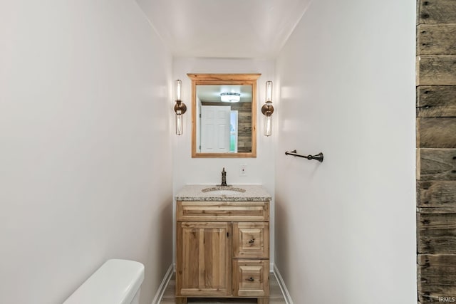 503 Graceland Ave, Claypool, IN 46510 - bathroom featuring vanity, toilet, and baseboards