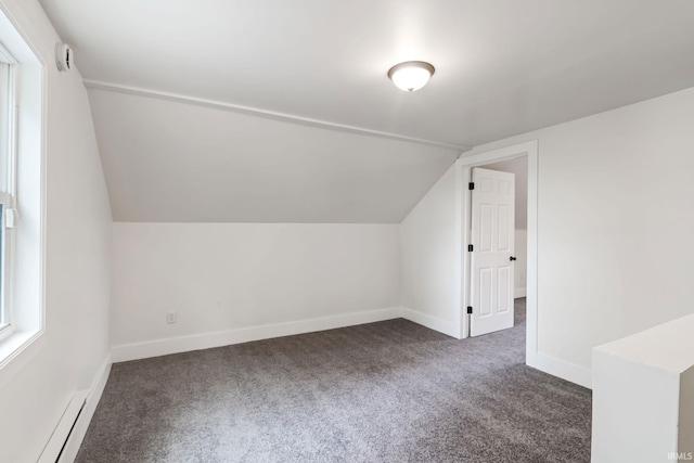 503 Graceland Ave, Claypool, IN 46510 - bonus room with dark colored carpet, a baseboard radiator, lofted ceiling, and baseboards