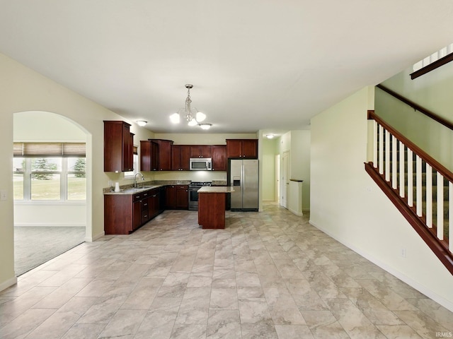 13395 Synch Ct, Fort Wayne, IN 46814 - kitchen featuring appliances with stainless steel finishes, a chandelier, a sink, light countertops, and baseboards