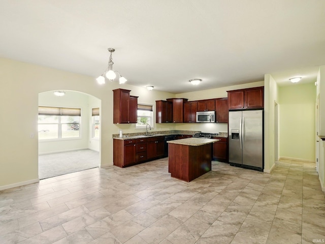 13395 Synch Ct, Fort Wayne, IN 46814 - kitchen featuring appliances with stainless steel finishes, a sink, arched walkways, a center island, and hanging light fixtures