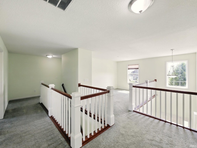 13395 Synch Ct, Fort Wayne, IN 46814 - corridor featuring an upstairs landing, carpet floors, baseboards, and a textured ceiling