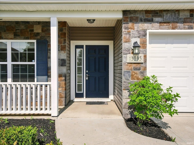 13395 Synch Ct, Fort Wayne, IN 46814 - property entrance featuring stone siding, a garage, and a porch