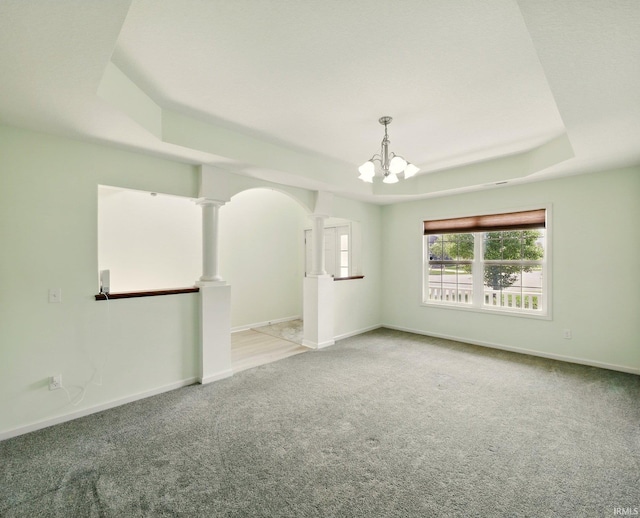 13395 Synch Ct, Fort Wayne, IN 46814 - spare room with a raised ceiling, carpet floors, a chandelier, ornate columns, and baseboards