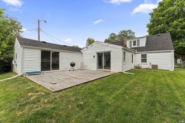 2527 Woodmont Dr, South Bend, IN 46614 - back of property with a deck, a yard, central AC, and roof with shingles