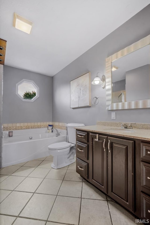 230 Meadows Dr, Greentown, IN 46936 - bathroom featuring tile patterned flooring, vanity, a garden tub, and toilet