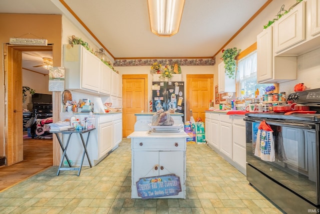 5528 N 250 W Unit 27, Lafontaine, IN 46940 - kitchen featuring black range with electric stovetop, ornamental molding, light countertops, freestanding refrigerator, and light stone finish floors