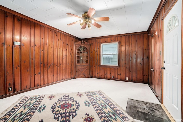 1826 E Donald St, South Bend, IN 46613 - foyer with ceiling fan, wood walls, carpet floors, and crown molding