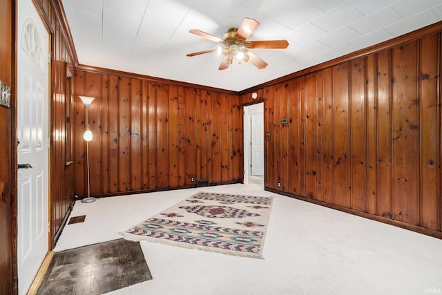 1826 E Donald St, South Bend, IN 46613 - carpeted empty room featuring a ceiling fan, wood walls, and crown molding
