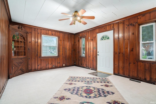 1826 E Donald St, South Bend, IN 46613 - foyer with light carpet, wood walls, a ceiling fan, and ornamental molding