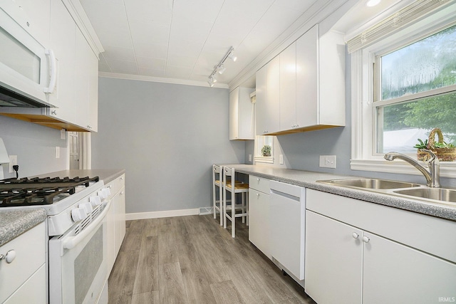 1826 E Donald St, South Bend, IN 46613 - kitchen featuring white appliances, ornamental molding, light wood-style floors, white cabinets, and a sink