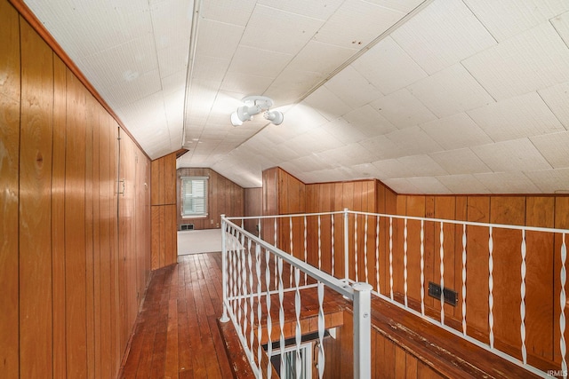 1826 E Donald St, South Bend, IN 46613 - hallway featuring wooden walls, dark wood-type flooring, vaulted ceiling, and an upstairs landing