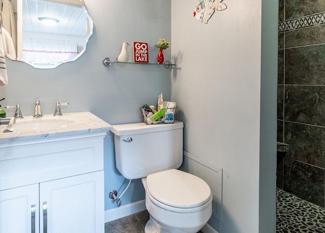 620 Ln 330 Big Otter Lk, Fremont, IN 46737 - full bathroom featuring toilet, tiled shower, vanity, baseboards, and tile patterned floors