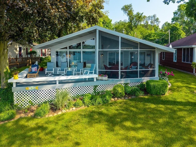 620 Ln 330 Big Otter Lk, Fremont, IN 46737 - back of property featuring a deck, a sunroom, and a yard