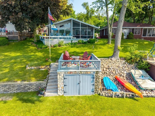620 Ln 330 Big Otter Lk, Fremont, IN 46737 - view of green lawn featuring a sunroom and a wooden deck