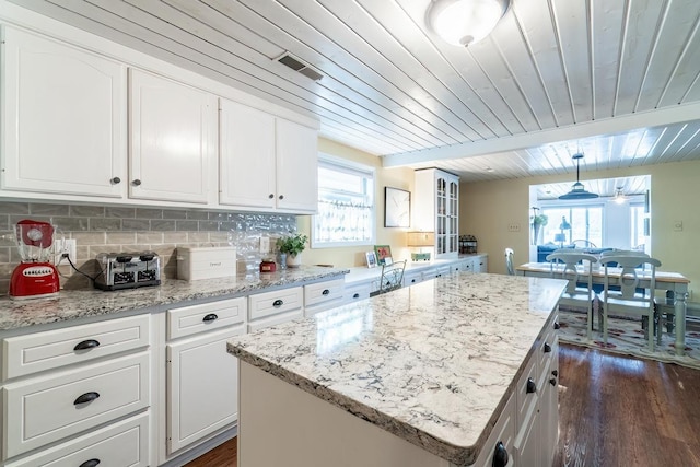 620 Ln 330 Big Otter Lk, Fremont, IN 46737 - kitchen with wooden ceiling, dark wood-style floors, white cabinetry, backsplash, and a kitchen island